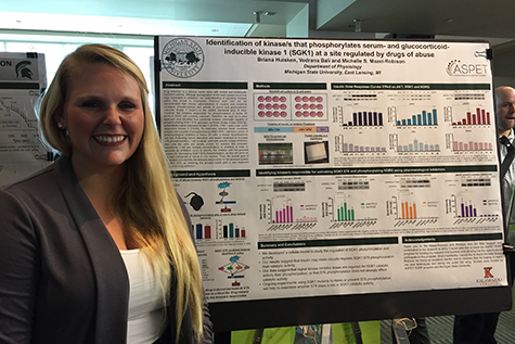 Briana presents her poster at mid-SURE